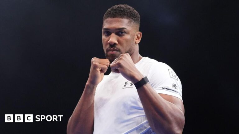 Eddie Hearn ‘expects’ Anthony Joshua to fight again after crash Anthony Joshua holds up his fists