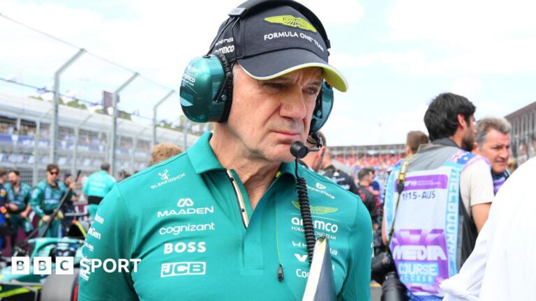 F1 Q&A: Verstappen and Red Bull, Newey and Aston Martin, Audi, Cadillac and F1’s sustainable fuel Adrian Newey pictured in an Aston Martin polo shirt at the Australian Grand Prix, with an Aston Martin car behind him to the right. Newey us holding a folder and wearing a headset