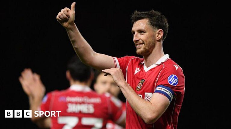 Wrexham captain Dom Hyam gives a thumbs up after the win over Oxford United
