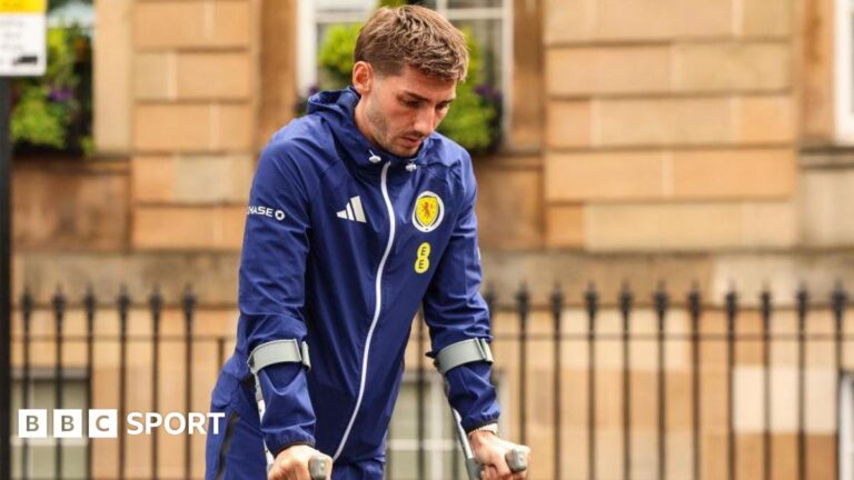 Scotland's Billy Gilmour leaves the team hotel on crutches