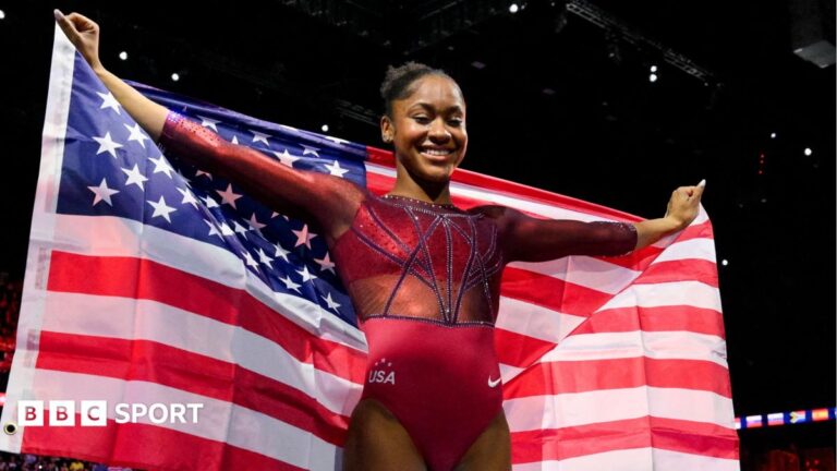 Skye Blakely holds the stars and stripes aloft after winning gold